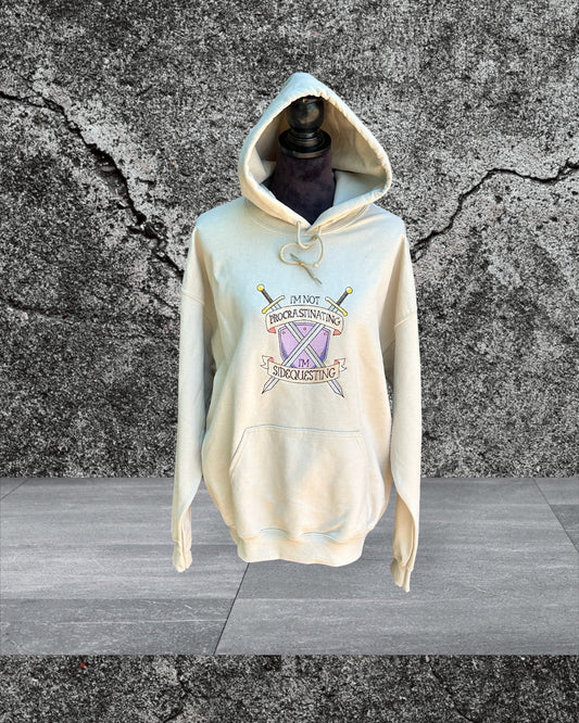 Procrastinating and Sidequesting Shield Hoodie